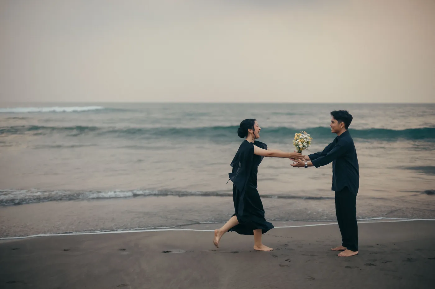 Bastian and Vero laughing together by the sea