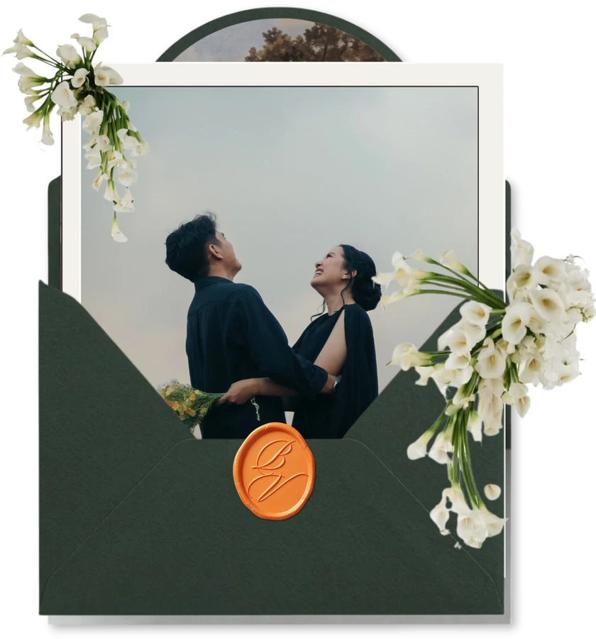 Bastian and Vero looking at each other under an open sky, tucked into an open envelope with calla lilies