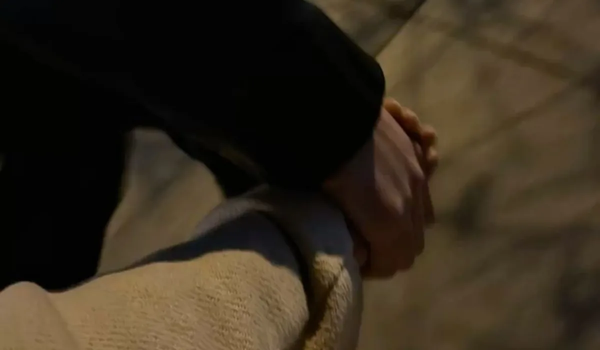 Bastian and Vero holding hands on a night walk